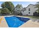 Backyard view with a large in-ground pool, deck, and fenced yard at 3457 Skyview Dr, Lithia Springs, GA 30122