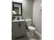 Powder room featuring modern vanity, framed mirror, neutral colors, and tile flooring at 3457 Skyview Dr, Lithia Springs, GA 30122