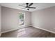 Bedroom featuring a ceiling fan, light gray paint, wood-look flooring, and natural lighting at 3457 Skyview Dr, Lithia Springs, GA 30122