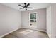 Bright bedroom with a window view, ceiling fan, light gray paint, and wood-look flooring at 3457 Skyview Dr, Lithia Springs, GA 30122