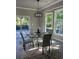 Bright dining area with a glass table, stylish chairs, and sliding door access to the deck at 3457 Skyview Dr, Lithia Springs, GA 30122