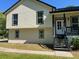 Well-maintained home featuring a light-colored exterior with black window trim and a welcoming front entrance at 3457 Skyview Dr, Lithia Springs, GA 30122