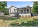 Beautifully renovated two-story home featuring a charming front porch and mature trees at 3457 Skyview Dr, Lithia Springs, GA 30122
