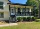 Charming home featuring a covered front porch with black railings and decorative lighting at 3457 Skyview Dr, Lithia Springs, GA 30122