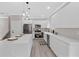 Bright kitchen with white cabinetry, stainless steel appliances, and a large center island with pendant lighting at 3457 Skyview Dr, Lithia Springs, GA 30122