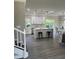 Modern kitchen featuring stainless steel appliances, white cabinetry, a center island, and gray wood flooring at 3457 Skyview Dr, Lithia Springs, GA 30122