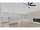 Bright open-concept living room with a ceiling fan, fireplace, and an open view of the modern kitchen at 3457 Skyview Dr, Lithia Springs, GA 30122