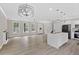 Bright open-concept living room featuring hardwood floors, modern lighting, and stainless steel appliances at 3457 Skyview Dr, Lithia Springs, GA 30122