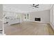 Open-concept living room featuring hardwood floors, fireplace, and an adjacent kitchen with a large island at 3457 Skyview Dr, Lithia Springs, GA 30122