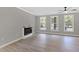 Bright living room featuring hardwood floors, a modern fireplace, and a view of the backyard at 3457 Skyview Dr, Lithia Springs, GA 30122