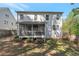 Spacious backyard showcasing a screened porch and well-maintained lawn, perfect for outdoor entertaining at 4965 Skyland Pkwy, Cumming, GA 30028