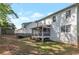 Wide view of the backyard highlighting a screened porch, fenced perimeter, and ample space for recreation at 4965 Skyland Pkwy, Cumming, GA 30028