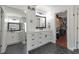 Modern bathroom features double vanities, sleek black hardware, and a large mirror enhancing the sense of space at 4965 Skyland Pkwy, Cumming, GA 30028