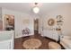 Charming Bedroom featuring stylish decor, a delightful book stand, and warm wooden floors at 4965 Skyland Pkwy, Cumming, GA 30028