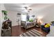 Bright bedroom featuring hardwood floors, a ceiling fan, and playful decor at 4965 Skyland Pkwy, Cumming, GA 30028