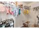 Organized closet with hanging clothes, shelving for shoes, and ample storage space at 4965 Skyland Pkwy, Cumming, GA 30028