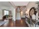 Inviting foyer with hardwood floors, a staircase, and elegant decor, creating a warm entry into the home at 4965 Skyland Pkwy, Cumming, GA 30028