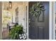 Inviting front porch with a decorative wreath on the black front door and stylish outdoor seating at 4965 Skyland Pkwy, Cumming, GA 30028
