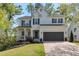 Charming two-story home featuring black shutters, a two-car garage, and a beautifully landscaped front yard at 4965 Skyland Pkwy, Cumming, GA 30028