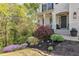 Close-up of the front yard featuring vibrant landscaping and decorative plants leading to the home's entrance at 4965 Skyland Pkwy, Cumming, GA 30028