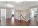 Hallway with hardwood floors, neutral paint, and multiple doorways leading to various rooms at 4965 Skyland Pkwy, Cumming, GA 30028