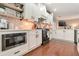 Stylish kitchen featuring white cabinets, stainless steel appliances, and brick backsplash at 4965 Skyland Pkwy, Cumming, GA 30028
