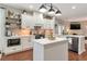 Elegant kitchen with white cabinets, brick backsplash, and stainless steel appliances at 4965 Skyland Pkwy, Cumming, GA 30028