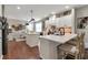 Bright kitchen features white cabinets, an island with seating, and stainless steel appliances at 4965 Skyland Pkwy, Cumming, GA 30028