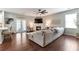 Comfortable living room with a white brick fireplace, hardwood floors, and a sectional sofa creates a cozy and inviting space at 4965 Skyland Pkwy, Cumming, GA 30028