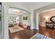Inviting living area with hardwood floors, neutral walls, and decorative columns at 4965 Skyland Pkwy, Cumming, GA 30028