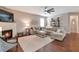 Bright and airy living area featuring a fireplace, large sectional, and hardwood floors at 4965 Skyland Pkwy, Cumming, GA 30028