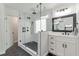 Updated bathroom featuring a glass-enclosed shower, white vanity, and black hardware accents at 4965 Skyland Pkwy, Cumming, GA 30028