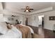 Bright main bedroom with hardwood floors, tray ceiling, and open access to a bathroom and closet at 4965 Skyland Pkwy, Cumming, GA 30028