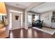 Spacious home office featuring hardwood floors, a large desk, and natural light, perfect for remote work at 4965 Skyland Pkwy, Cumming, GA 30028