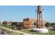 Street view of a commercial real estate development showcasing a Coal Mountain water tower in a vibrant, pedestrian-friendly area at 4965 Skyland Pkwy, Cumming, GA 30028