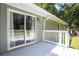 Green home featuring a well-lit back deck with white railing and sliding glass door at 879 Rock Oak Ln, Lawrenceville, GA 30046