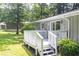 Backyard deck of home with white railings and stairs, and a door leading inside at 879 Rock Oak Ln, Lawrenceville, GA 30046