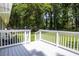 Backyard deck of a home with white railing overlooking a grassy area surrounded by trees at 879 Rock Oak Ln, Lawrenceville, GA 30046
