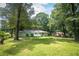 Green lawn and backyard with a deck, and a well-maintained home at 879 Rock Oak Ln, Lawrenceville, GA 30046