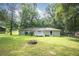 Green lawn and backyard with a deck, firepit, and a well-maintained home at 879 Rock Oak Ln, Lawrenceville, GA 30046
