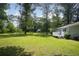 Spacious green lawn with a deck on a well-maintained home at 879 Rock Oak Ln, Lawrenceville, GA 30046