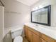 Bathroom featuring a wood vanity, an ornate mirror, lighting fixtures and a tub and shower at 879 Rock Oak Ln, Lawrenceville, GA 30046