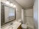 Bright bathroom features an ornate framed mirror and a shower with white tiling and curtains at 879 Rock Oak Ln, Lawrenceville, GA 30046