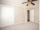 Bedroom with carpet, a closet, and doorway to another room, offering ample storage and space at 879 Rock Oak Ln, Lawrenceville, GA 30046