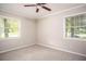 Bedroom with carpet, a ceiling fan, and windows with natural light, creating a relaxing and inviting space at 879 Rock Oak Ln, Lawrenceville, GA 30046