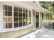 The home's well-lit entrance featuring a front porch with many large windows at 879 Rock Oak Ln, Lawrenceville, GA 30046