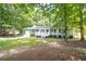 A quaint single-story house surrounded by lush greenery and a well-kept lawn at 879 Rock Oak Ln, Lawrenceville, GA 30046