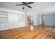 Spacious living room with hardwood floors, built-in shelving, and a ceiling fan at 879 Rock Oak Ln, Lawrenceville, GA 30046