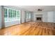 Bright living room with natural light, a stone fireplace, and hardwood floors at 879 Rock Oak Ln, Lawrenceville, GA 30046
