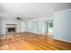 Spacious living room featuring a fireplace, hardwood floors, and access to the patio at 879 Rock Oak Ln, Lawrenceville, GA 30046